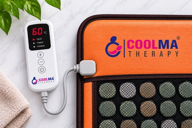 Close-up of the orange leatherette panel with the embroidered Coolma Therapy brand mark