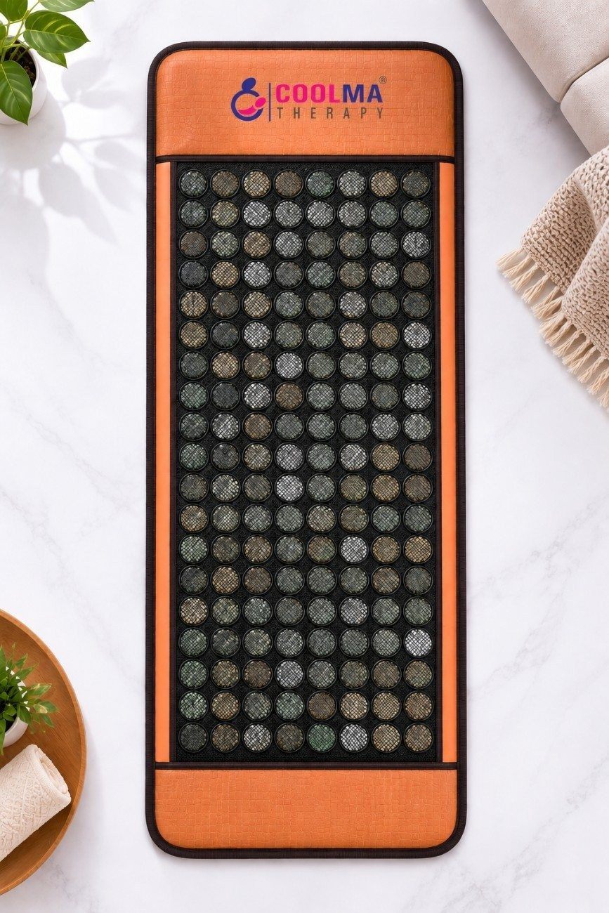 Full view of the Coolma Therapy Mat showing rows of round jade stones set into a black mesh bed with orange leatherette borders